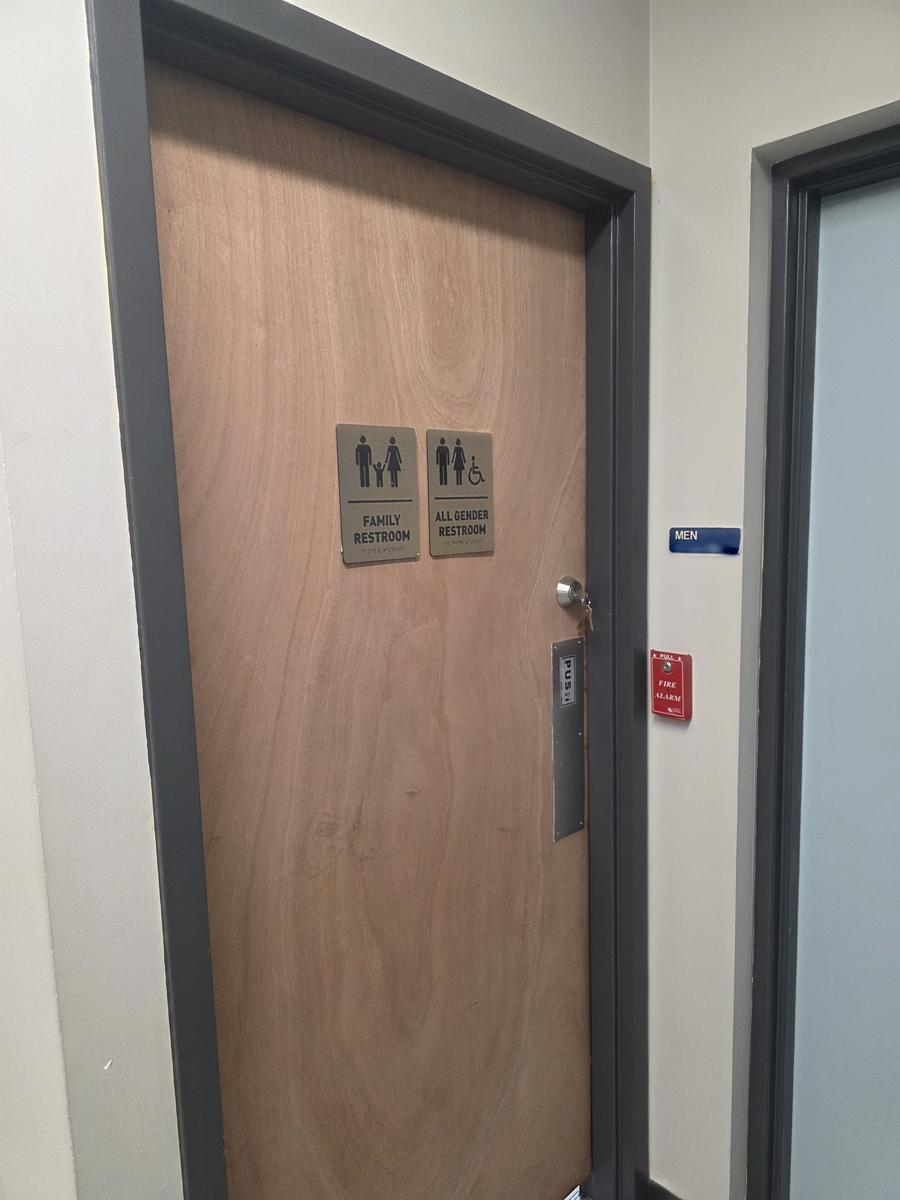 Commercial restroom door with deadbolt and ADA signage