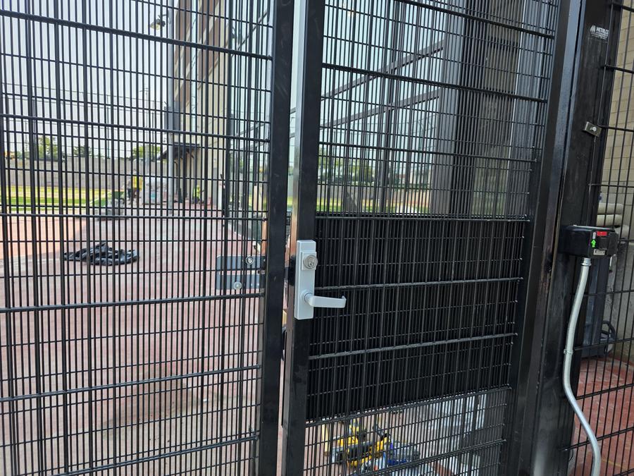 Commercial lever handle lockset on security fence gate