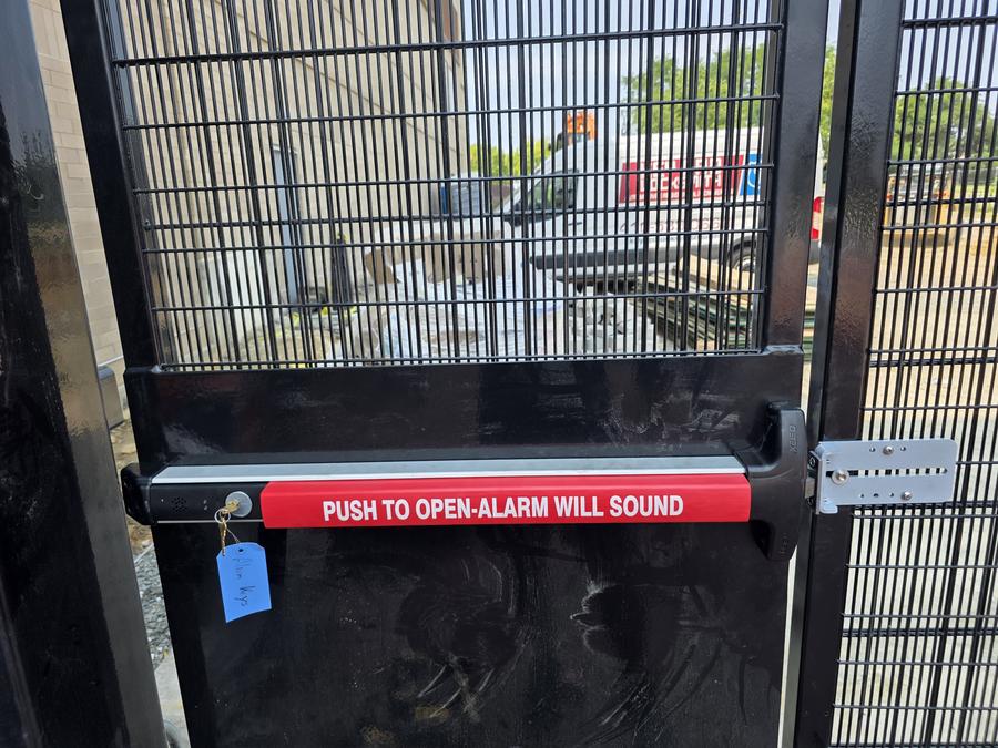 Detex panic exit device on commercial security gate